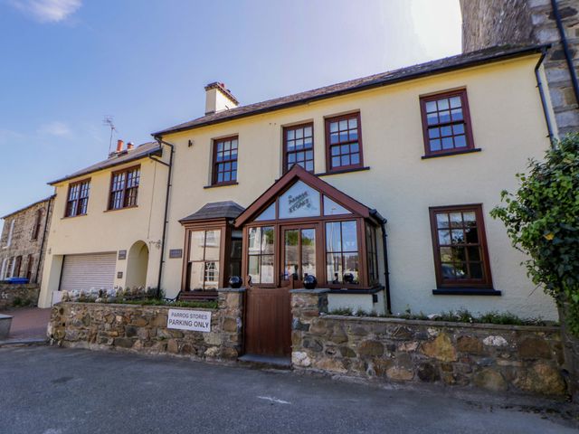 A building with a parking sign at Parrog Stores in Parrog near Newport, Pembrokeshire