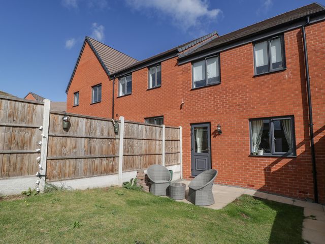 An outdoor area with a house and chairs at 15 Hey Close Malvern