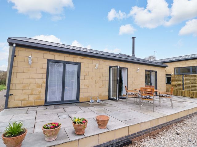 An outdoor seating area with a table and chairs at The Barn in Astwood Bank