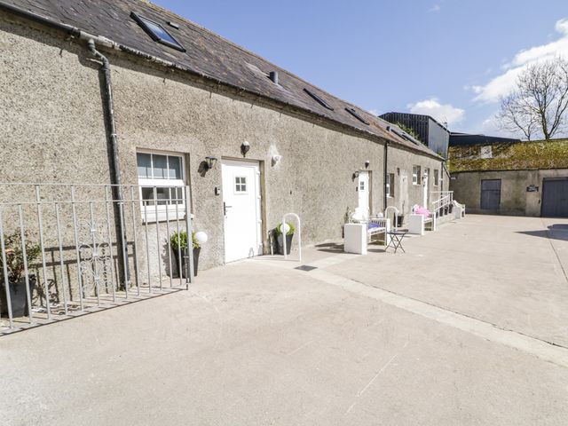 An outdoor area with a building and furniture at Derrywilligan 1,2,3 Newry