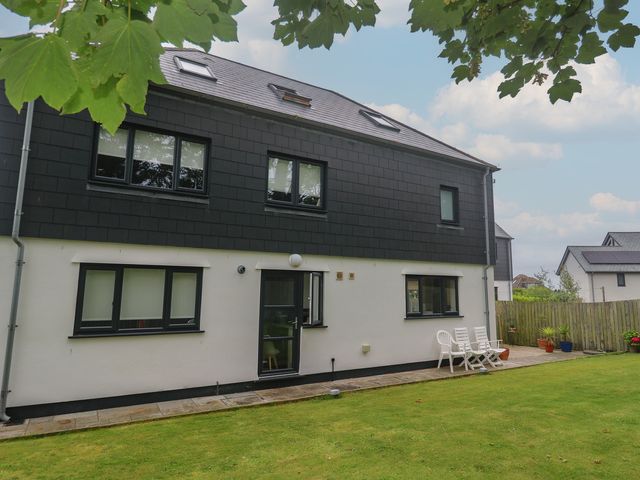 A house with a patio and chairs at Chy Holly in Carbis Bay