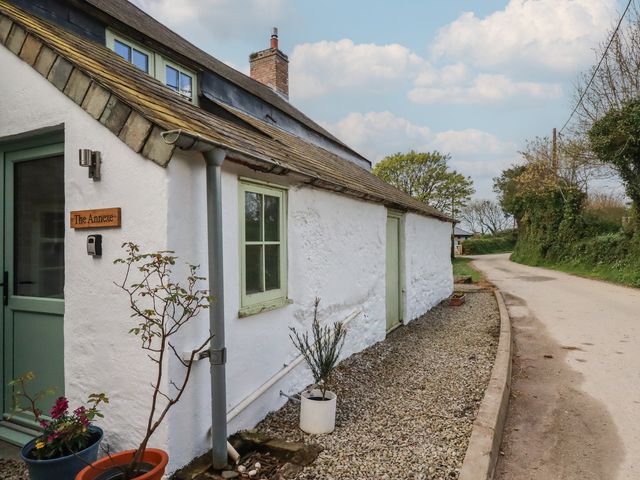 A cottage exterior with a sign at Trevarthian Farm (Annex) Kestle Mill near Quintrell Downs