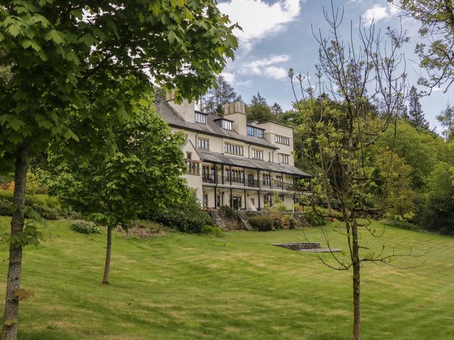 A house with a balcony and trees in the garden at Deer Wood At Applethwaite Hall Windermere
