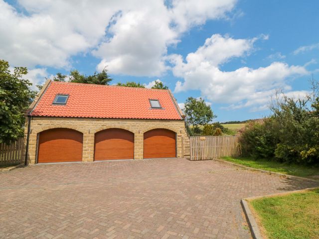 A garage with three doors at Heron Nest in Cloughton near Scarborough