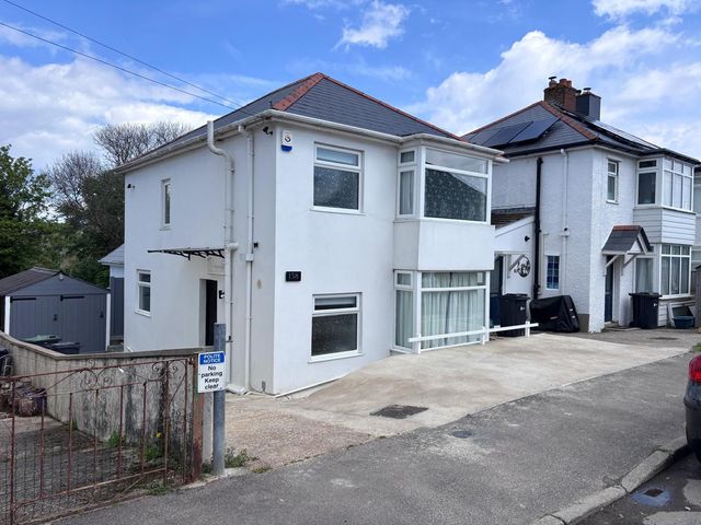 A house with a garage and driveway at The Swanage Rail Lookout in Swanage