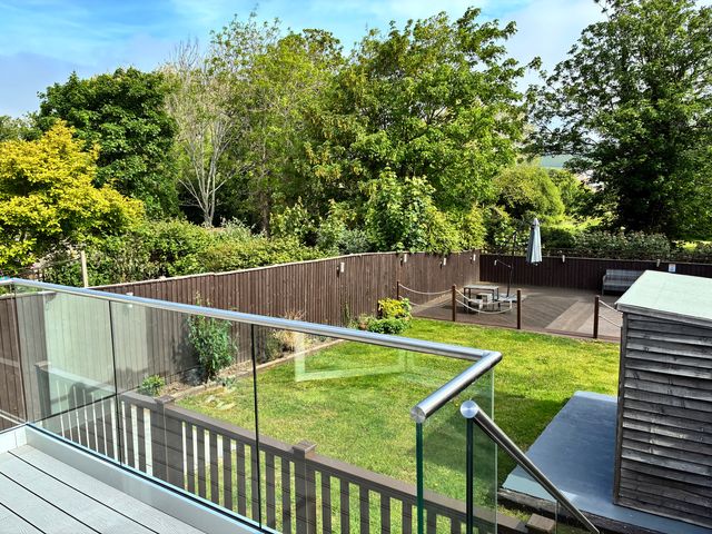 A garden with a deck and seating area at The Swanage Rail Lookout in Swanage