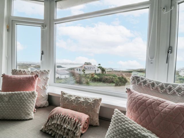 A snug with cushions and a view at No.7 Plas Darien Trearddur Bay