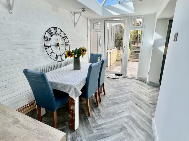 A dining room with a table and chairs at 51 North Street in Wareham