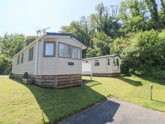 Two mobile homes on a grass lawn with trees in the background at 26 Manleigh Park in Combe Martin