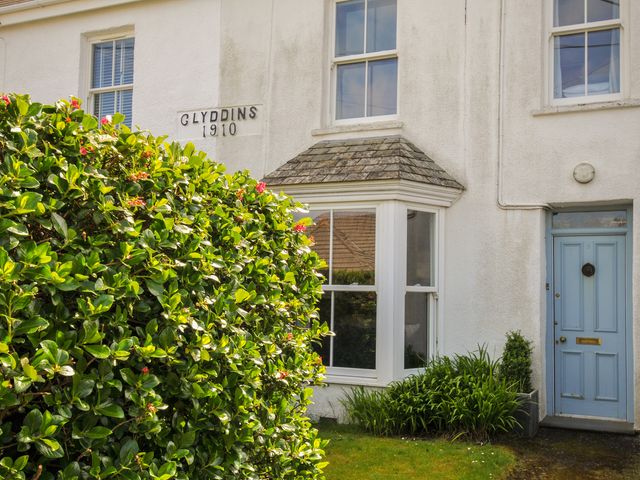 An exterior view of a house with a blue door at 2 Glyddins 1910, Rock