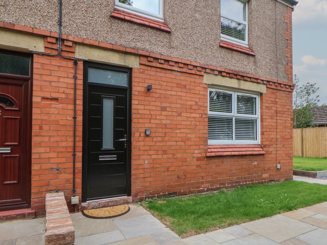 An exterior view of a brick building with a front door and windows at 5 Marsh Lane in Flint