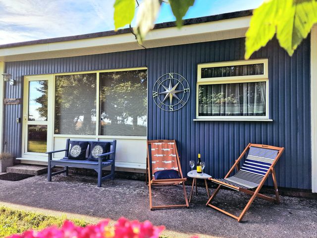 An outdoor seating area with chairs and a table at Driftwood in Dartmouth