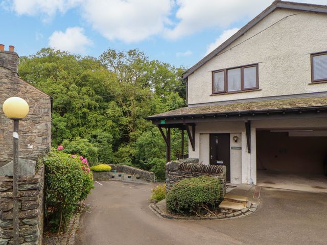 A building with a garage and garden at Waterfall in Ambleside