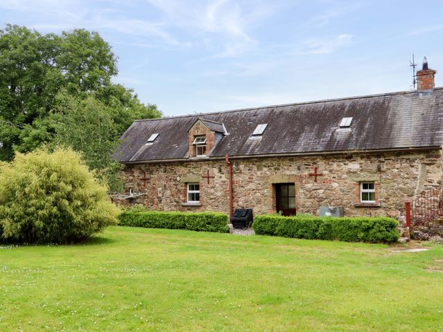 A house with a garden and trees at Orchard Barn Wexford