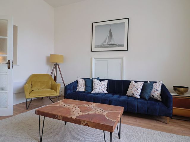 A living room with a sofa and coffee table at Saltwind in Lyme Regis