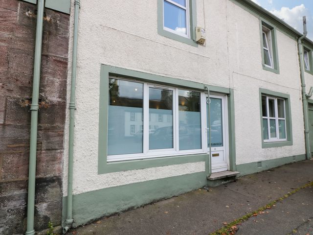 The exterior of a white building with green trim around windows and door at West Morton Suite in Thornhill