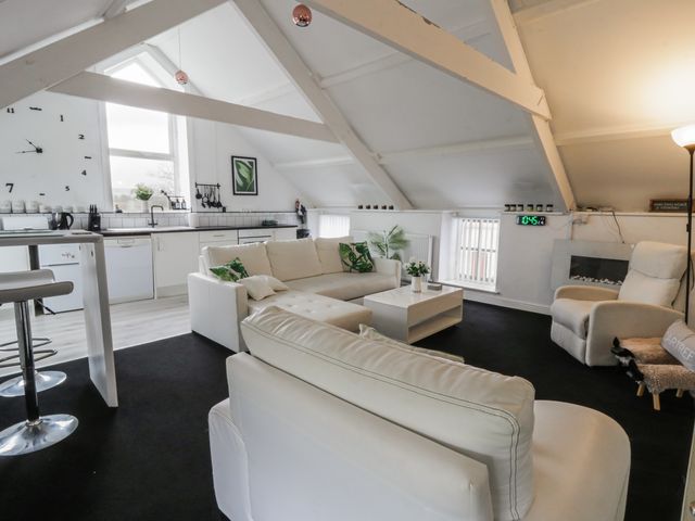 A living room with a sofa and coffee table at The Old Workshop in Dre-Fach near Lampeter