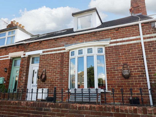 A brick house with a window and door at 8 Percy Terrace, Whitburn