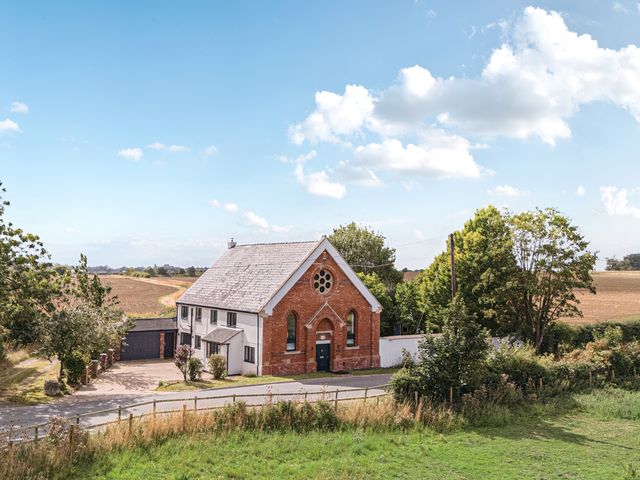 A house with a garage and trees at The Old Chapel in Glentworth near Ingham