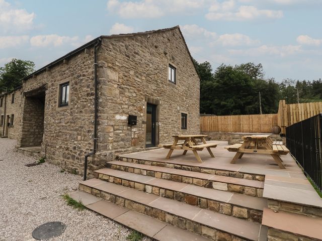 A stone house with steps and picnic tables at Virginia Cottage Skipton