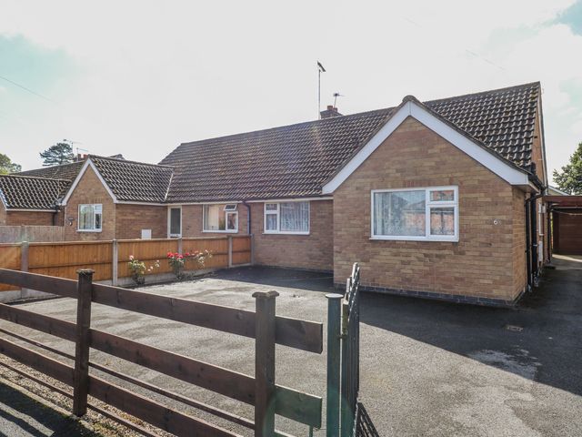 A bungalow exterior with a fence and driveway at 6 Pine Walk in Uttoxeter