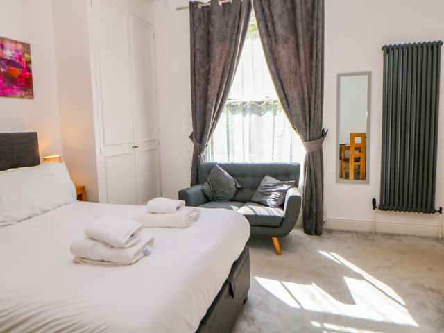 A bedroom with a bed and couch at Lumsdale in Matlock Bath