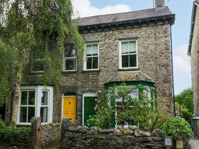 A house with yellow and green doors and garden at 28 Rock Villas in Carnforth