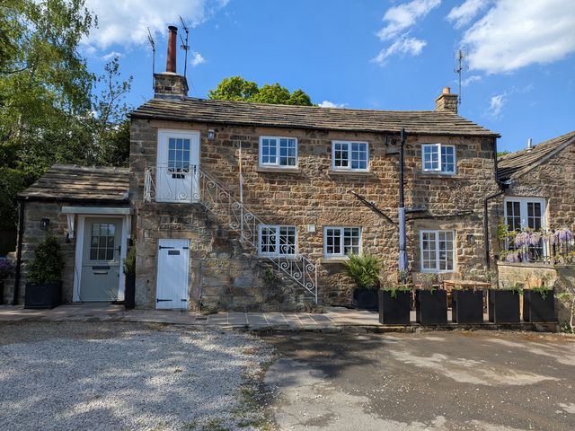 A house with stairs and plants at Bridge House Cottage Burn Bridge near Harrogate