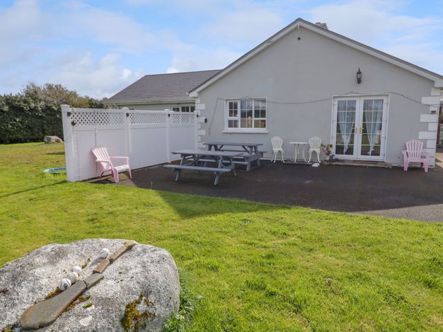 A patio with picnic tables and chairs outside a house at Thomond Hill in Narin County Donegal