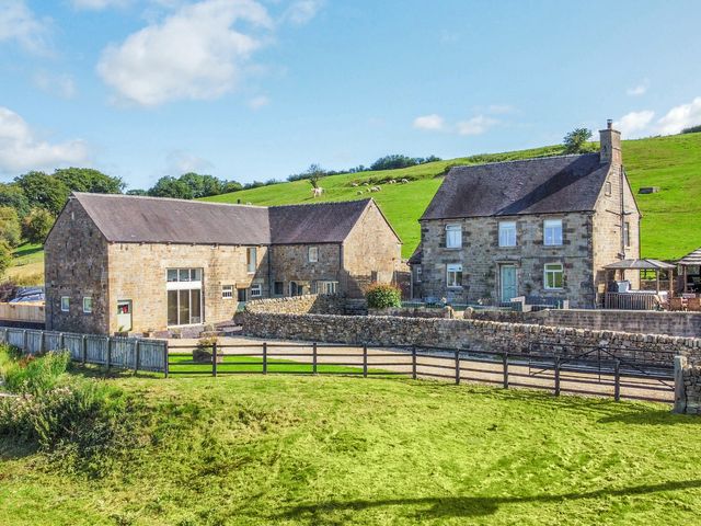 A house and stone building with a grassy area at Pastures Barn Bradnop near Leek
