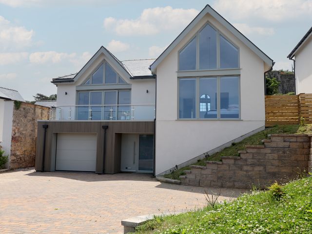 A house with a garage and balcony at Golygfa Gele in Llanddulas