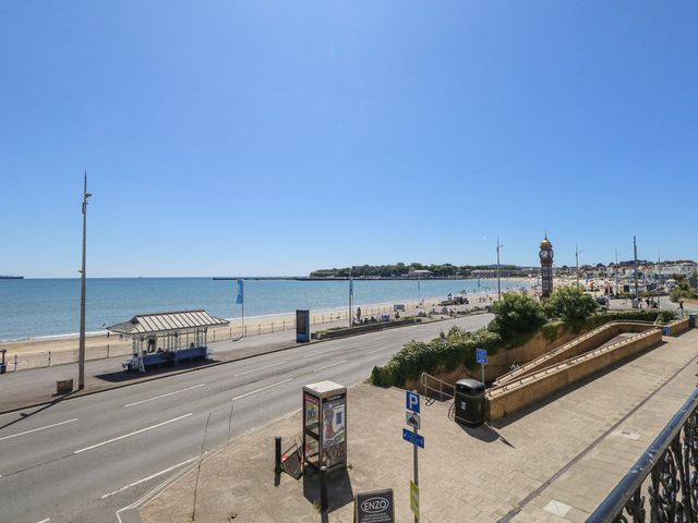 A beach and ocean view with a clock tower in Weymouth