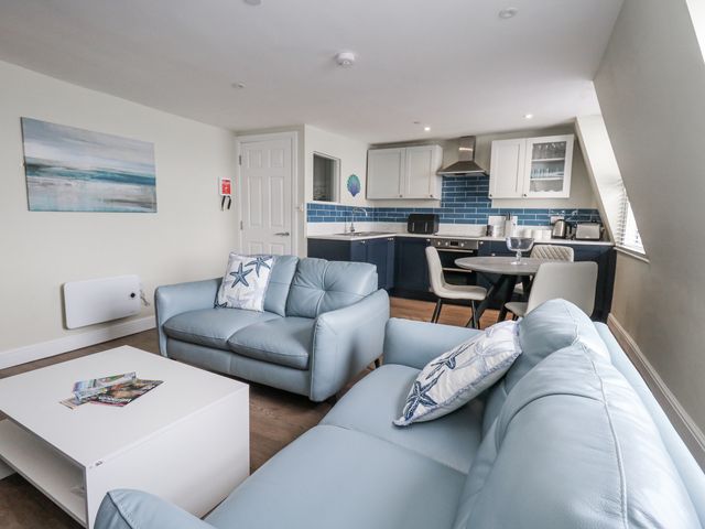 A living room with a sofa and a coffee table at Vista Mare 3 in Weymouth