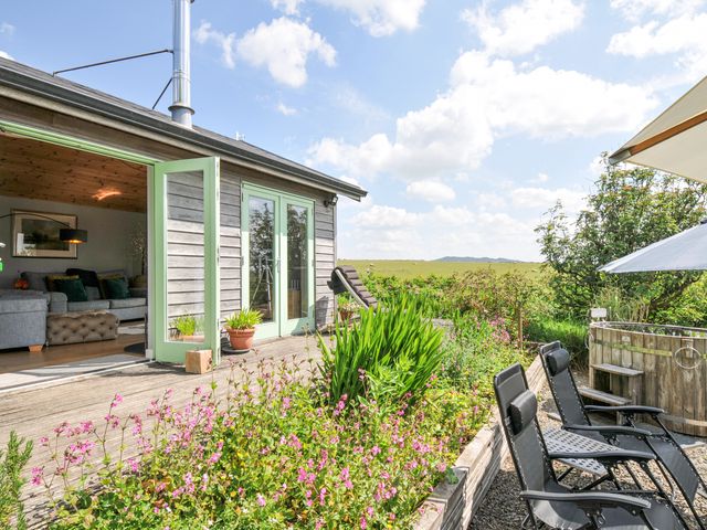 An outdoor area with seating and flowers at Smugglers Bodmin Moor, St Breward near St Tudy
