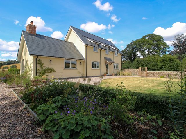 A house with a garden and fence at Hoddell Pitch Cottage Kinnerton near New Radnor