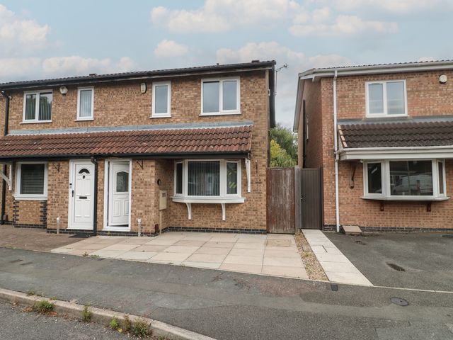 A house with a front door and windows at 12 Gorse Lane Syston
