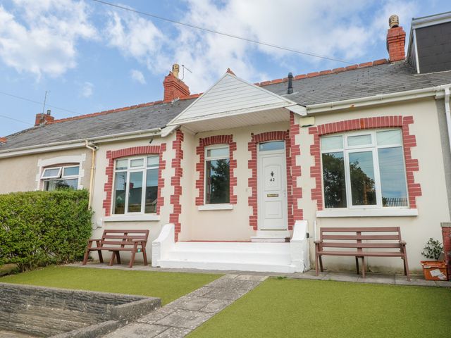 A house with windows and benches in front at The Bungalow in Porthcawl