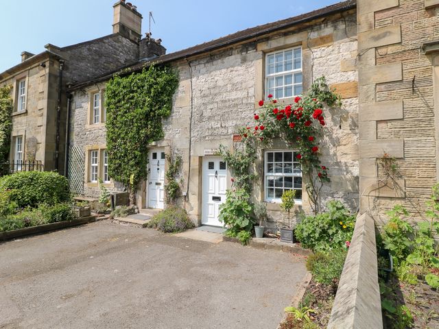 A house with doors and windows surrounded by plants at Rose Cottage in Hartington