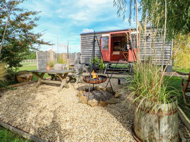 An outdoor area with a fire pit and seating at Bonnie's Shepherds Hut at Shepherds Lodge Retreat and Wellness Bottesford near Redmile and Vale of Belvoir
