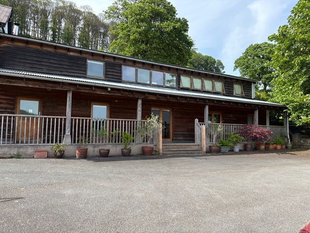 A wooden house with plants and steps at Cottage 1 in Presteigne