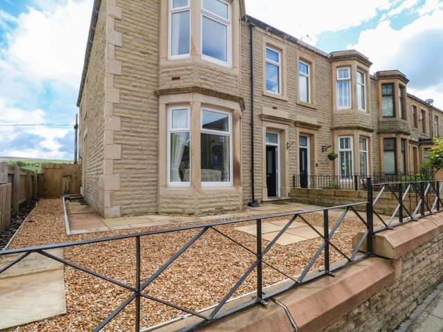 A house with a garden and pathway at 163 Manchester Road in Accrington