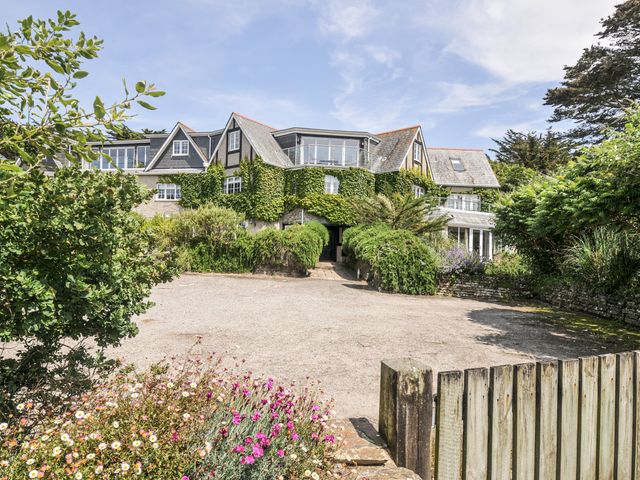 A house surrounded by greenery and flowers at Bodare 8 Daymer Bay