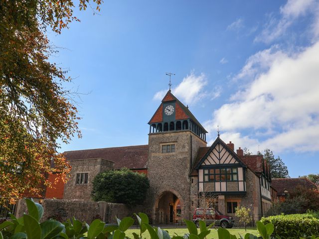 A clock tower building with a car in front at The Clock Tower in Rousdon, Nr Lyme Regis