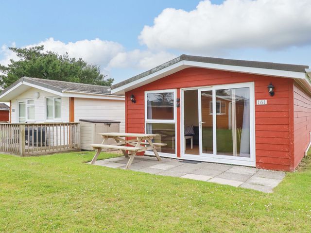 A cabin with a deck and bench at 161 Atlantic Bay Holiday Park Padstow