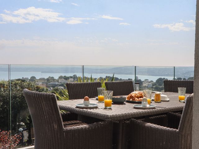 An outdoor dining area with a table set for breakfast at Seacroft in Torquay