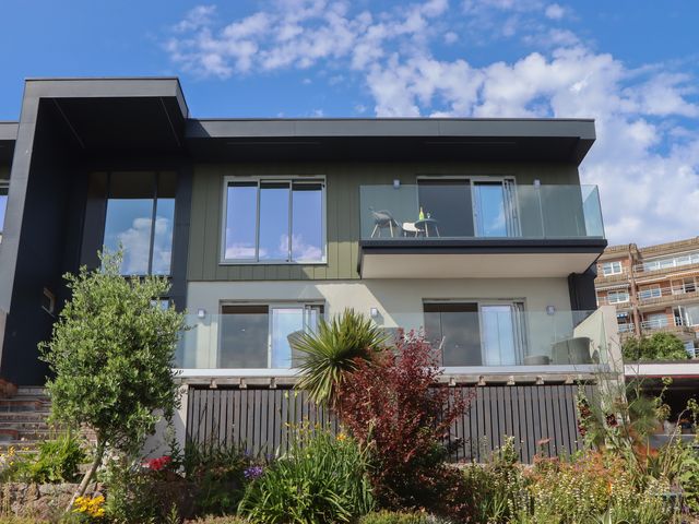 An outdoor view of a house with balconies and plants at Seacroft in Torquay