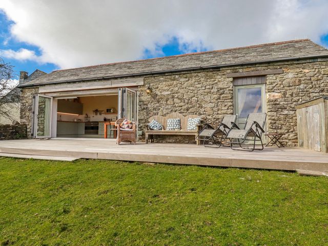 An outdoor area with chairs and a view at Roughtor Barn in Poldue near Camelford