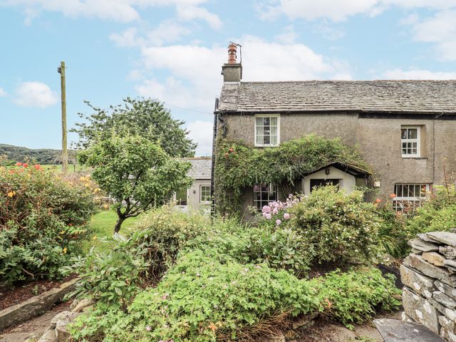 A garden surrounding a stone house at Old Cottage in Oxen Park near Ulverston