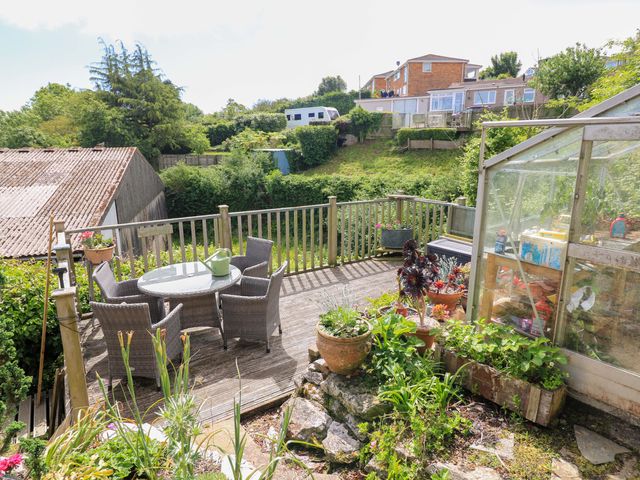 A garden area with a table and chairs at Garden View in Hillhead near Brixham