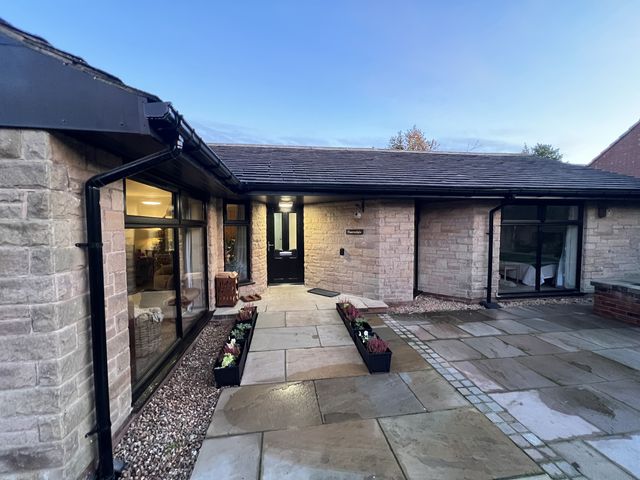An entrance area with stone features and a pathway at Havendale in Chesterfield